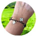 Armband met zwarte facetkralen en klavertjes